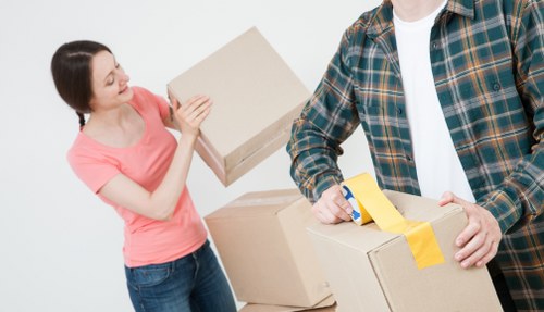 Staff handling packed boxes with careful lifting practices