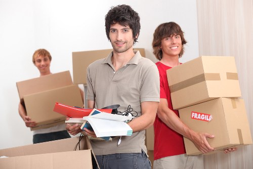 Mover carrying furniture during a residential relocation
