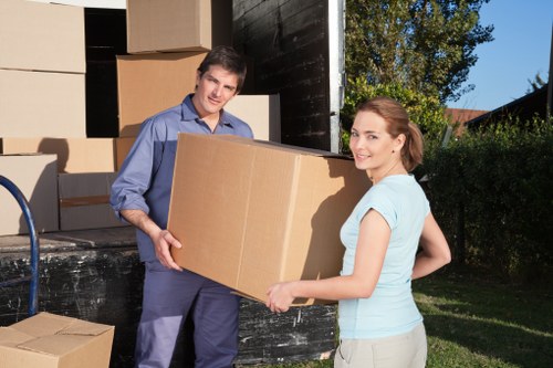 Removal staff wearing PPE while handling furniture carefully