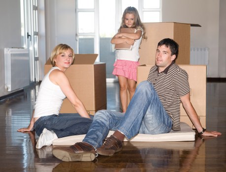 Professional movers carrying furniture through a residential property in Wimbledon